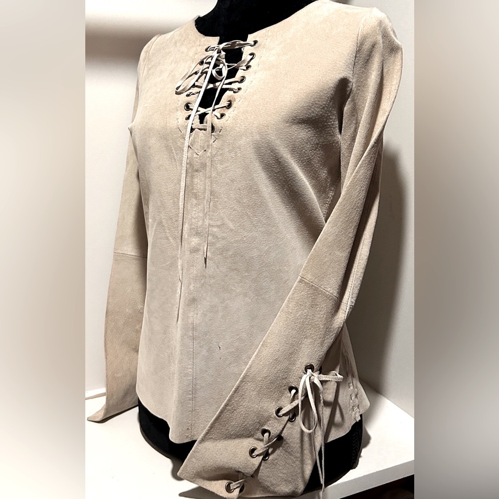 Vintage leather 70’s style top size small.  With laced up sleeves and neckline